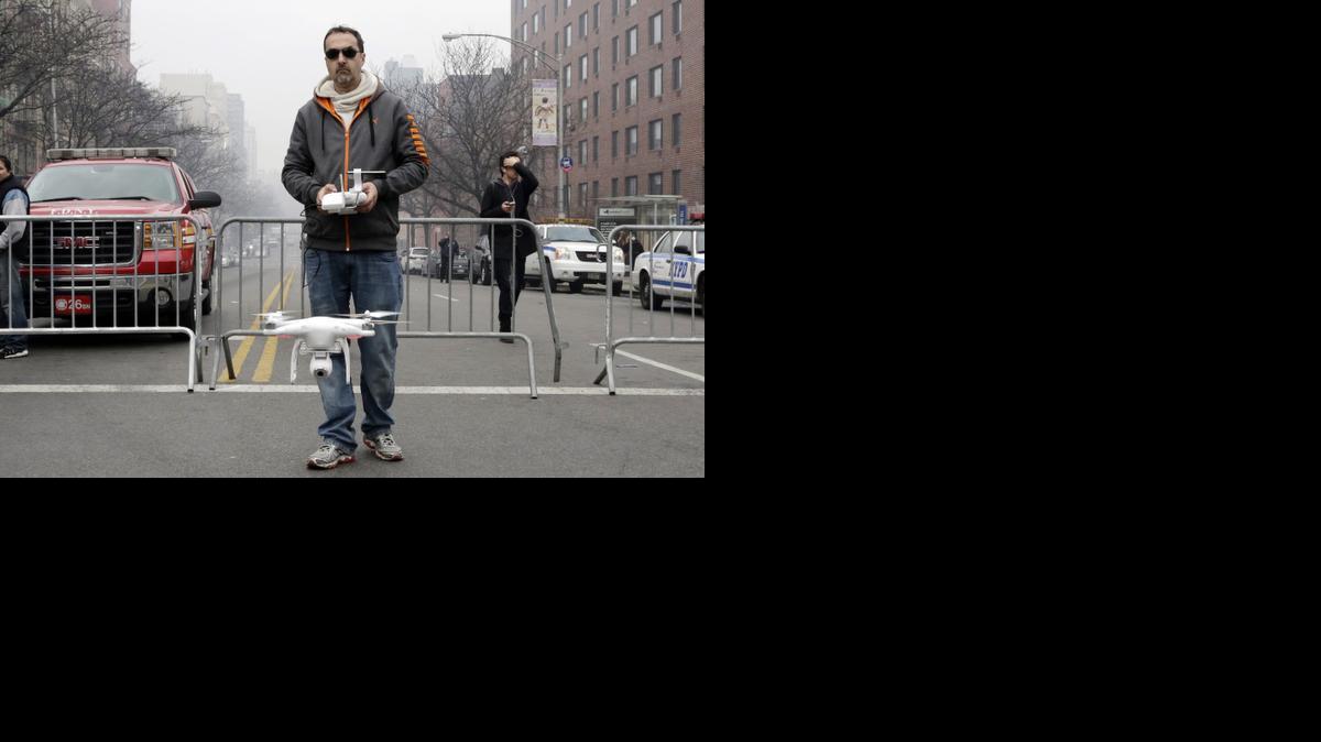 
Brian Wilson launches a small drone equipped with a video camera to fly over the scene of an explosion that leveled two apartment buildings in the East Harlem neighborhood of New York
