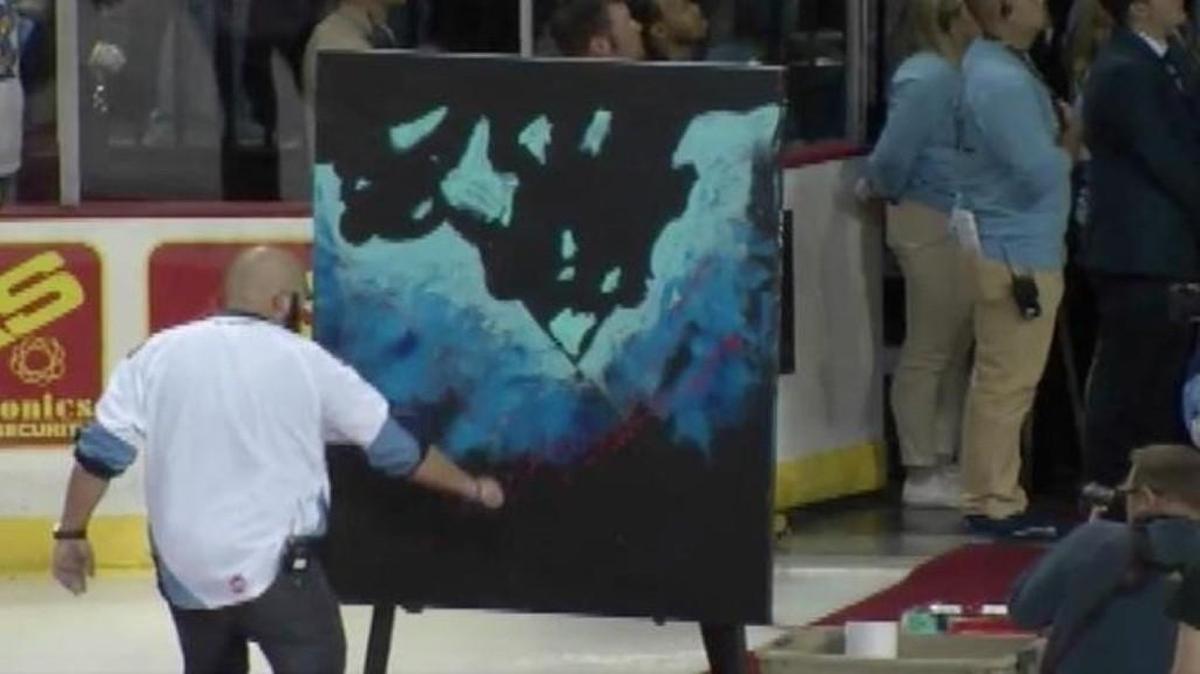 Artist Joe Everson sang the national anthem while painting a mural before a hockey game Saturday in Toledo, Ohio. His performance has since gone viral.
