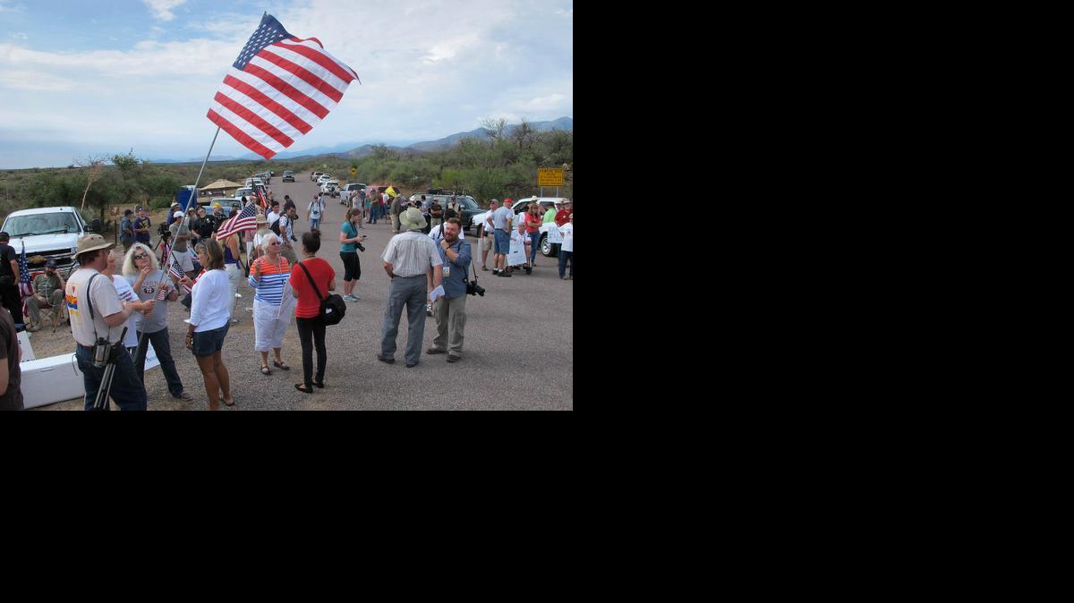 
Protesters gather near the entrance to juvenile facility in an effort to stop a bus load of Central American immigrant children from being delivered to the facility.
