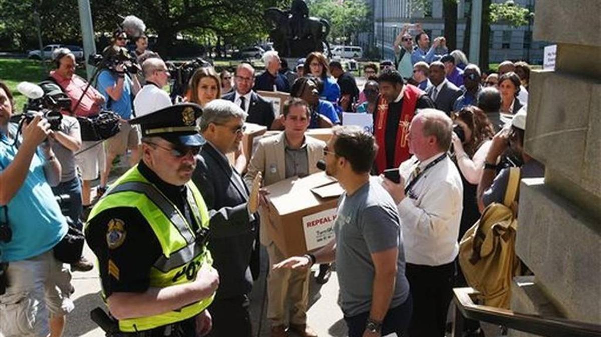 State Rep. Chris Sgro, D-Guilford, who is also executive director of Equality NC, center, is stopped at the Capitol steps by security with petitions against House Bill 2 in Raleigh, N.C., Monday, April 25, 2016. Tempers are flaring as supporters and opponents of the new North Carolina transgender law hold competing rallies to sway legislators starting their annual session
