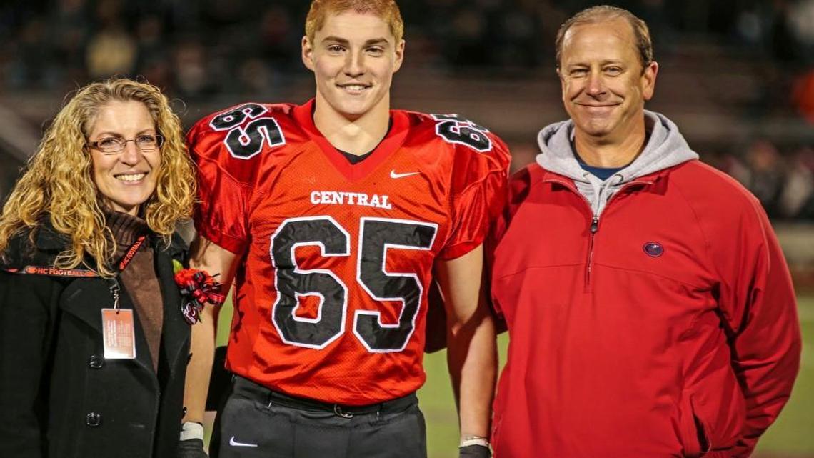 This Oct. 31, 2014, photo provided by Patrick Carns shows Timothy Piazza, center, with his parents Evelyn Piazza, left, and James Piazza, right, during Hunterdon Central Regional High School football's "Senior Night" at the high school's stadium in Flemington, N.J.