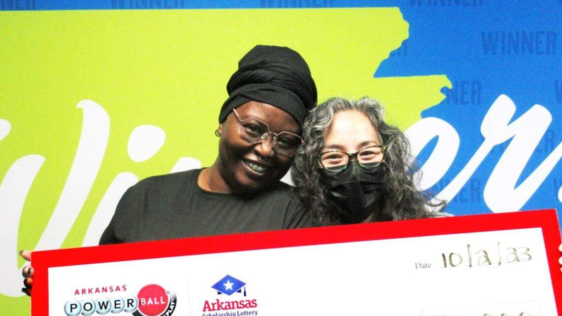 Joanna J., left, with her best friend, LeaAnn, and an oversized check.