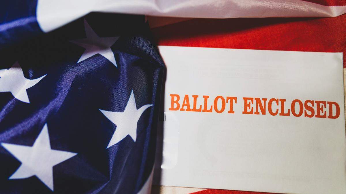 He is charged with destroying or misplacing a ballot and theft, police say.