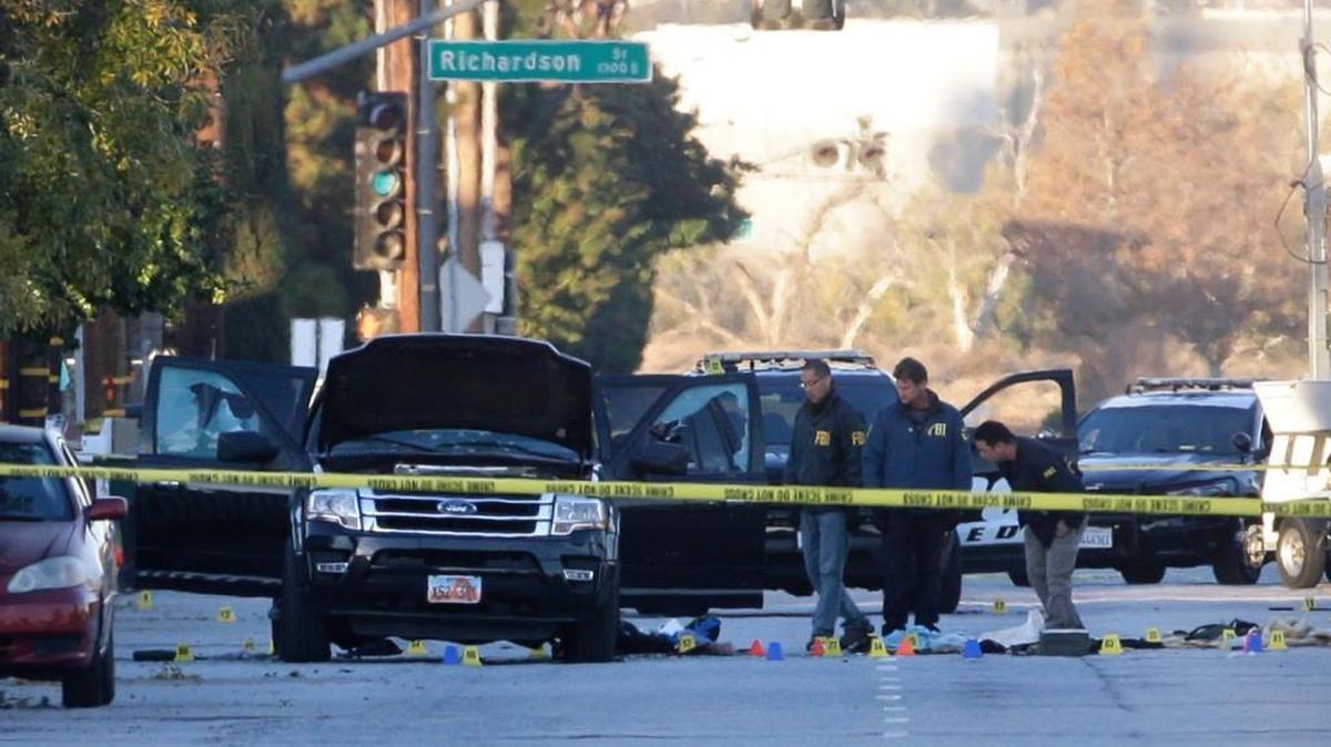 Authorities investigate the scene Thursday where a police shootout with suspects took place Wednesday in San Bernardino, Calif.