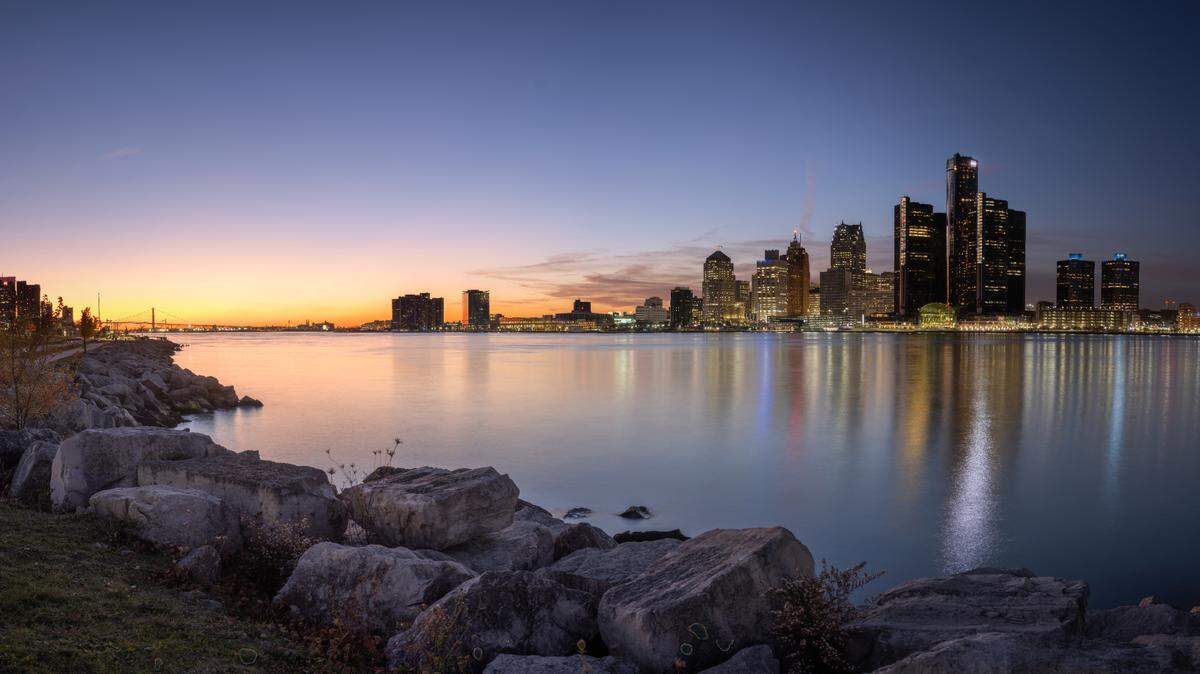 The man was using a life ring to swim across the Detroit River, the crew of the U.S. mail boat J.W. Westcott II said.