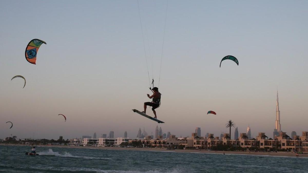 Wouldn’t you rather be kite surfing, like this man at Kite Beach in Dubai, United Arab Emirates, than working?