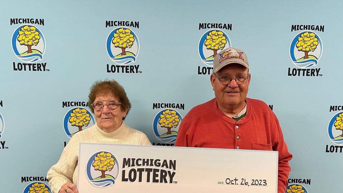 Charles Wolthuis, right, won a $1 million Powerball prize.