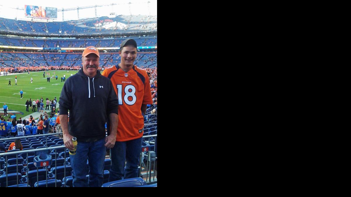 
Paul Kitterman, left, and his stepson Jarod Tonneson pose for a photo during a San Diego Chargers-Denver Broncos football game at Sports Authority Field in Denver. 
