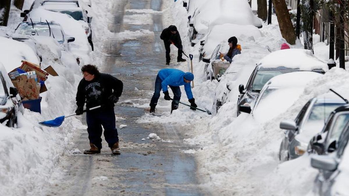 
People work to shovel snow-covered cars out in Boston's Charlestown section Jan. 28, a day after a blizzard dumped about two feet of snow in the city. The Old Farmer’s Almanac predicted more snow than usual in Boston last winter, when the Massachusetts capital was buried under more than 110 inches.
