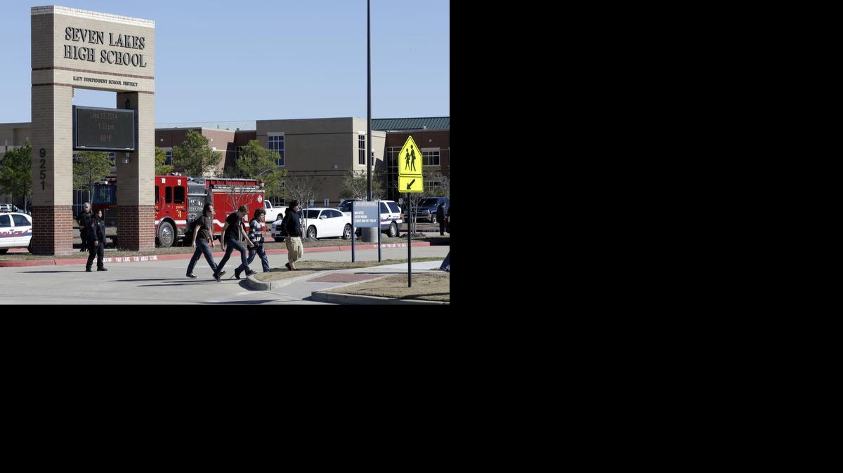 
Students pass by Seven Lakes High School in Texas after being evacuated released from school the day after a bomb squad was called the school after a potentially explosive device was found
