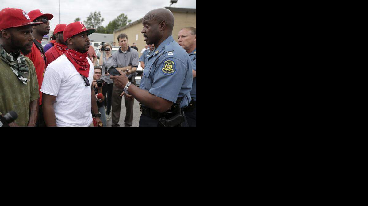 
Near the store in Ferguson, Mo., where Michael Brown allegedly stole cigars on Aug. 9, Missouri Highway Patrol Capt. Ron Johnson talked with several people Friday. “They have questions, and they’ve got concerns,” Johnson told a reporter.



