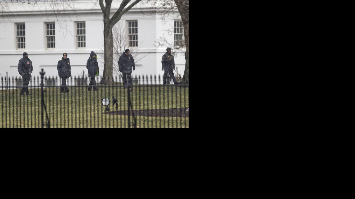 
Members of the Secret Service search the grounds of the North Lawn of the White House in Washington, Monday.
