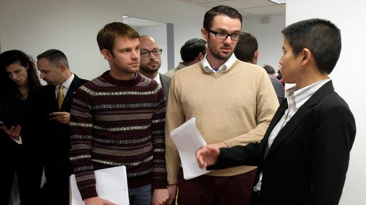 
In this 2012 file photo, Christine Sun (from right), deputy legal director for the Southern Poverty Law Center, talked with Michael Ferguson and his partner, Seth Anderson, before a news conference, in New York. Ferguson, of Salt Lake City, is one of four gay men accusing a New Jersey organization of selling “conversion therapy” services promising to make them straight. Instead, they told the news conference that they were subjected to humiliations, including having to strip naked, or taking a baseball bat to effigies of their mothers. 
