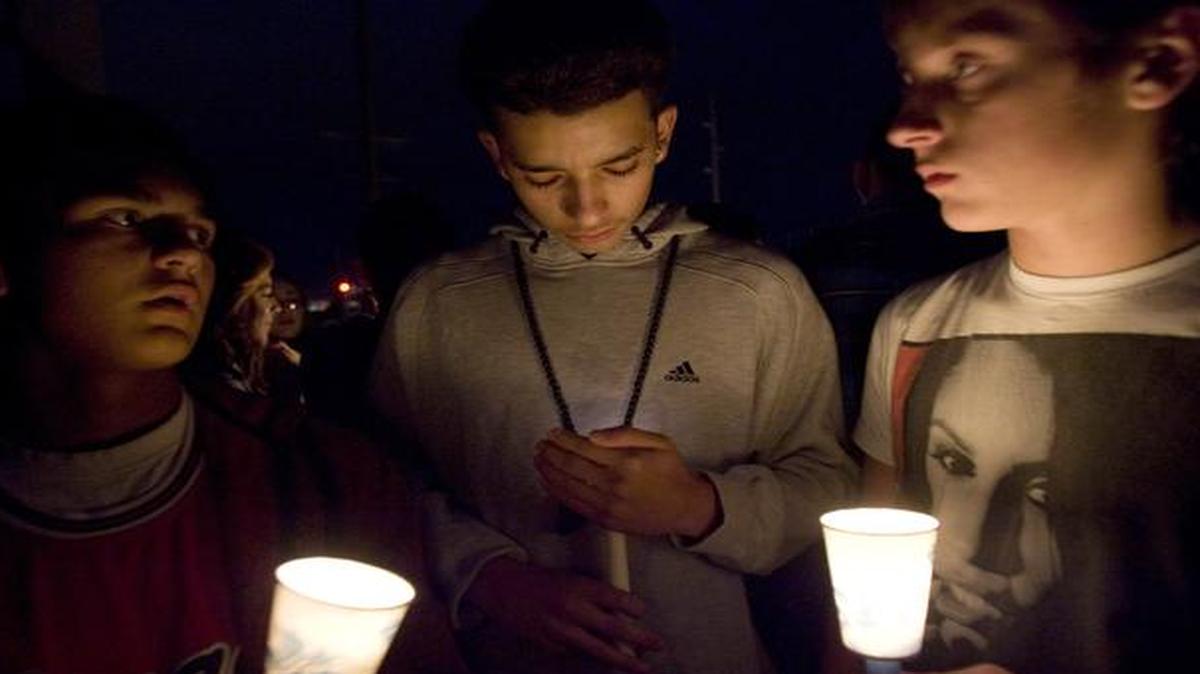 
Mourners hold candles during a vigil for a junior high school student who died in an apparent suicide in Taylorsville, Utah. 
