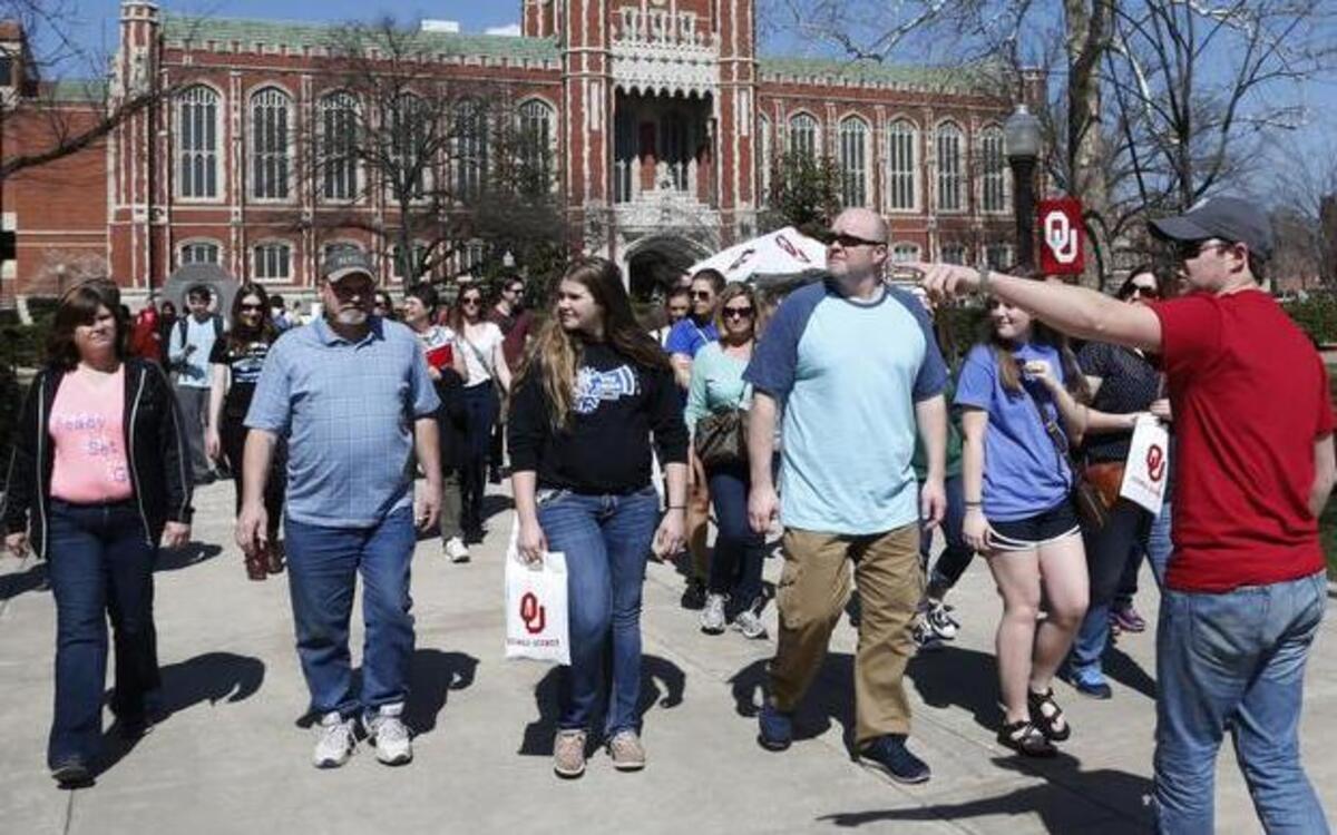 
University of Oklahoma senior Connor R. Bourland, right, of Wichita, leads a visitors tour along the South Oval on the campus in Norman, Okla., Wednesday.
