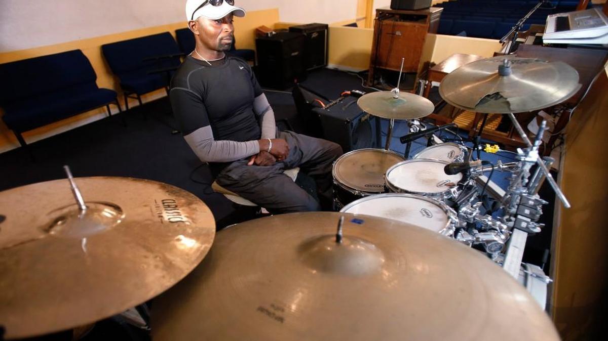 Fred Banks, uncle of 31-year-old Corey Jones who was fatally shot by a South Florida police officer, sits at the drum set that Jones played in church.