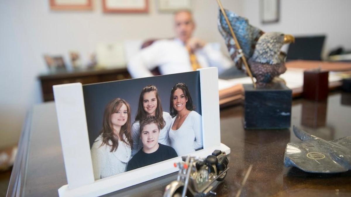 Adolfo Olivas, former Republican mayor of Hamilton, Ohio, in background, speaks behind a picture of his children at his office in downtown Cincinnati, Thursday. Olivas deactivated his Facebook account after GOP nominee Donald Trump's criticism of fellow Gold Star parents, the Muslim parents of Iraq war casualty Humayun Khan. “Just reading all of those comments justifying Mr. Trump’s outbursts,” said Olivas, whose son Nicholas, 20, was killed on Army patrol in Afghanistan in 2012. “I cannot stand to put up with the stupidity of those who will try to justify those words!”