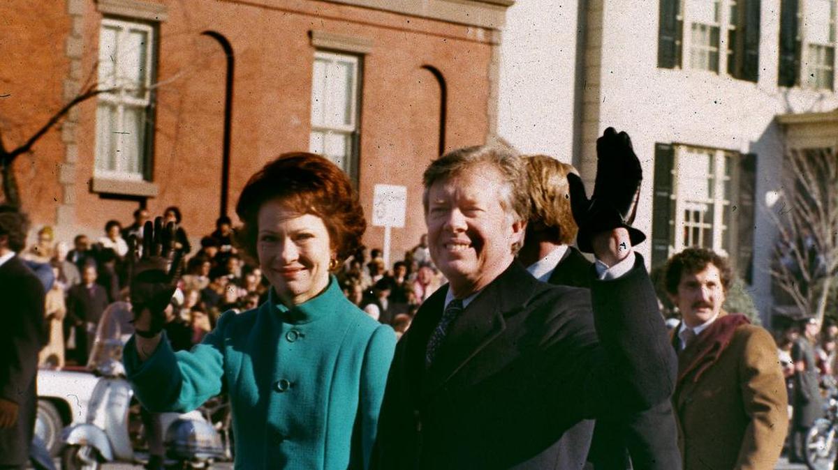 U.S. President Jimmy Carter, right, and his wife, first lady Rosalynn Carter, wave to the crowd as they walk down Washington’s Pennsylvania Avenue, Jan. 20, 1977. Carter was sworn in as the 39th president of the United States during the inauguration ceremonies. (AP Photo)