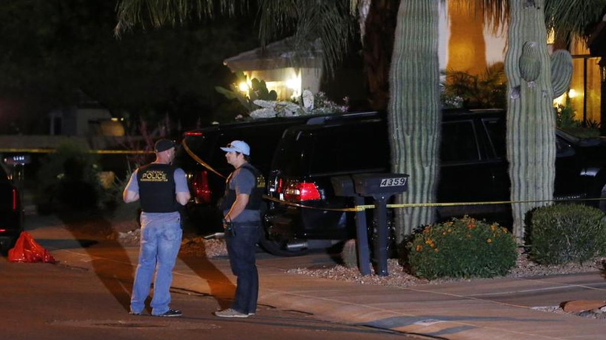
Phoenix Police Department officers in front of a house where authorities say five people were killed
