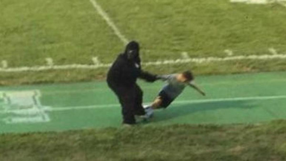 A photo posted to Reddit and Imgur on Saturday, taken at a Cincinnati area high school football game, shows someone in a gorilla costume pretending to drag a child along the sidelines.