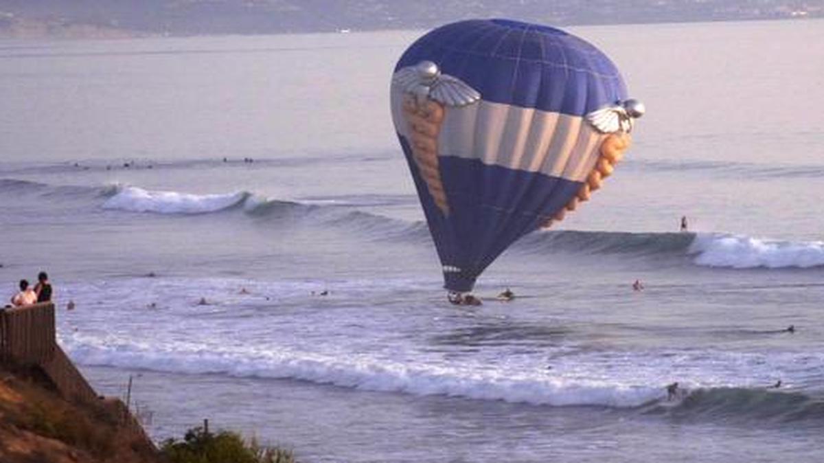 
A hot air balloon dips into the ocean in Cardiff-by-the-Sea, a beach community in Encinitas, Calif. 
