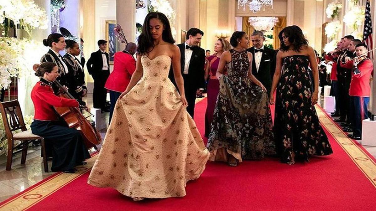 Malia Obama, left, and her sister Sasha walk out of their first State Dinner with their parents in March 2016. Malia Obama graduates high school on Friday.