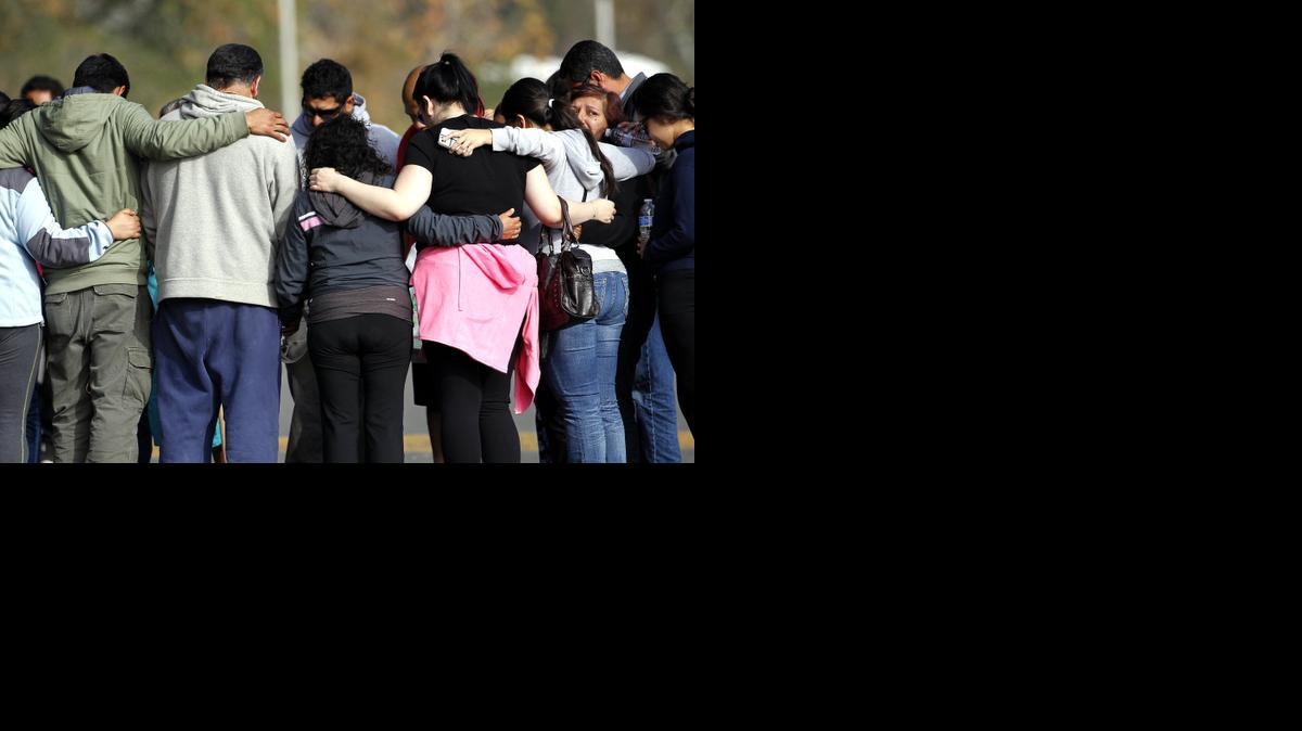 
Family and friends pray while waiting for a group of missing hikers at the entrance of Eaton Canyon, in Pasadena, Calif. on Monday
