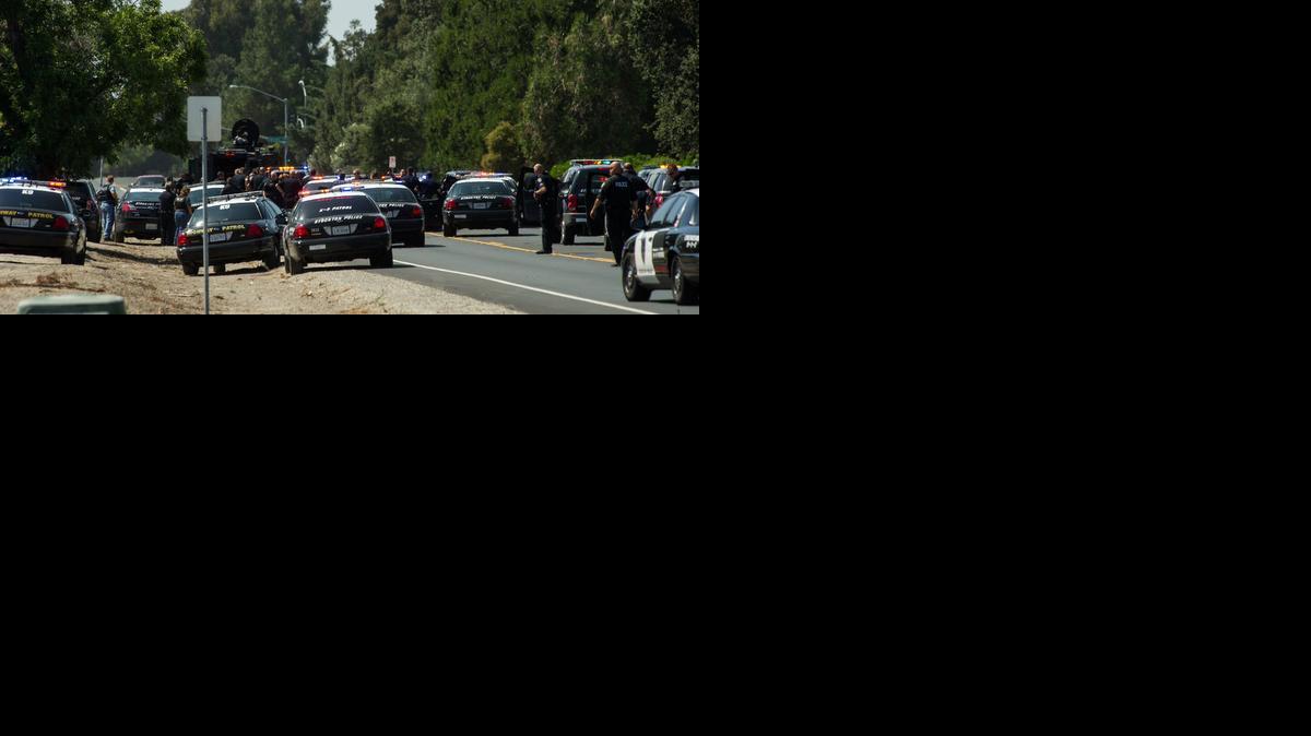 
Stockton Police officers at the scene where bank robbers with hostages were stopped Wednesday.
