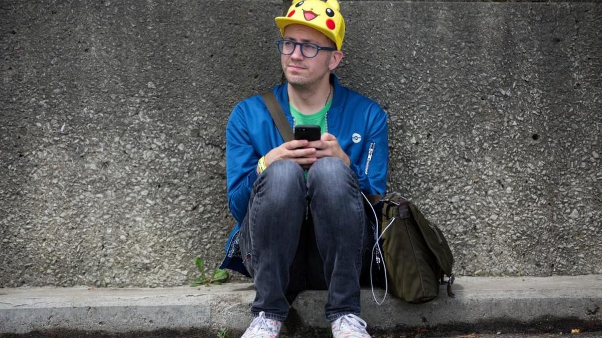 Ryan Copple of Los Angeles sat in the shade as he struggled to play Pokémon Go at the Pokémon Go Fest Saturday at Grant Park in Chicago.