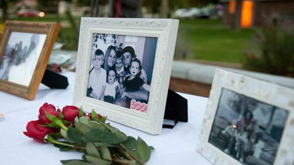 
In this Oct. 2 photo, flowers and photos were on display during a vigil for the Strack family at Pioneer Park in Provo, Utah. 
