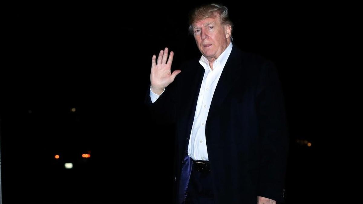 President Donald Trump waves as he walks on the South Lawn upon his return to the White House in Washington, from a five-nation Asia tour, Tuesday, Nov. 14, 2017.