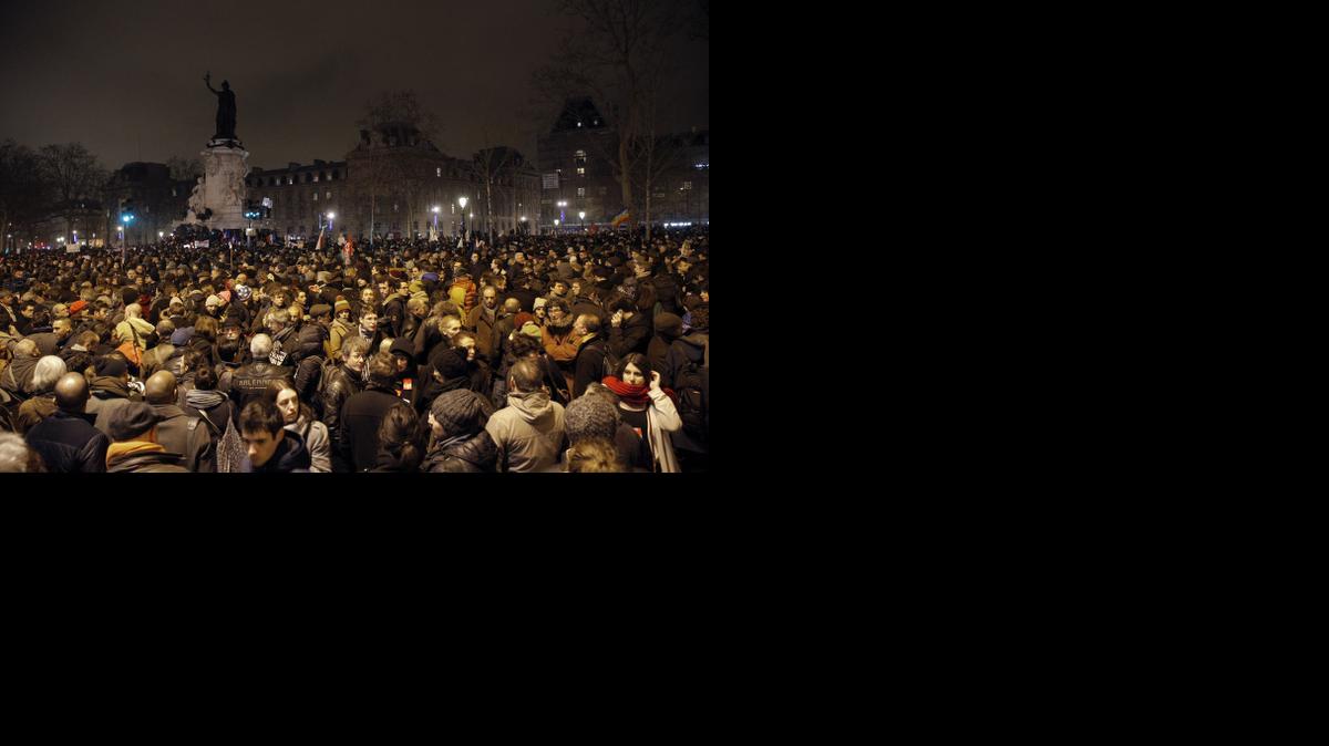 
Demonstrators gather at the Place de la Republique after a shooting at a French satirical newspaper in Paris, France, Wednesday. Three masked gunmen shouting "Allahu akbar!" stormed the Paris offices of a satirical newspaper, Charlie Hebdo, Wednesday, killing 12 people.
