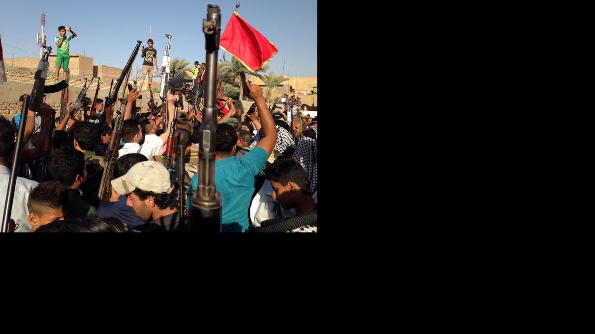 
Shiite tribal fighters raise their weapons and chant slogans against the al-Qaida-inspired Islamic State of Iraq and the Levant (ISIL) in the east Baghdad neighborhood of Kamaliya, Iraq, on Sunday.
