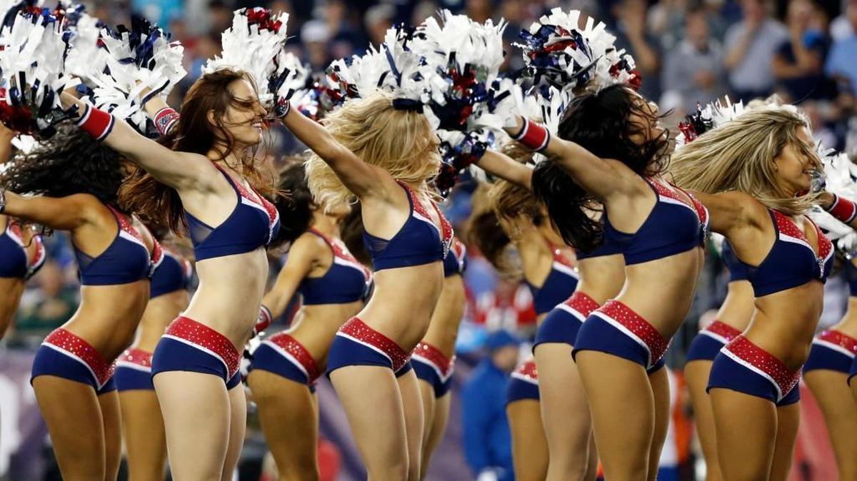 In a column for the Boston Globe, “Boston Public Radio” co-host Margery Eagan argues that “NFL cheerleaders and their barely covered breasts being ogled on the sidelines” is embarrassing for everyone. Cheerleaders for the New England Patriots are seen here.
