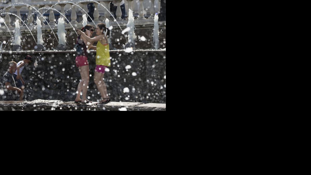 
Girls cool themselves in a fountain after a hot day at the Kremlin Wall in Moscow, Russia. 
