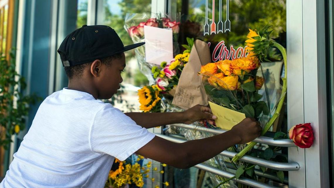 
A memorial at the Red Arrow Workshop in Lafayette, La., where shooting victim Jillian Johnson had worked, drew mourners Friday. Johnson and another woman, Mayci Breaux, were killed and nine people were injured in a cineplex shooting Thursday evening. Mason Matthews was among those who honored the victims Friday.
