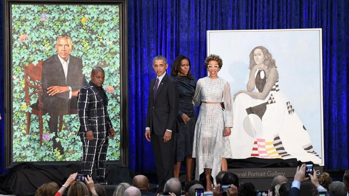 Former first lady Michelle Obama and former President Barack Obama pose with artists Kehinde Wiley and Amy Sherald during the unveiling of their official portraits at the National Portrait Gallery on Monday, February 12, 2018 in Washington, D.C.