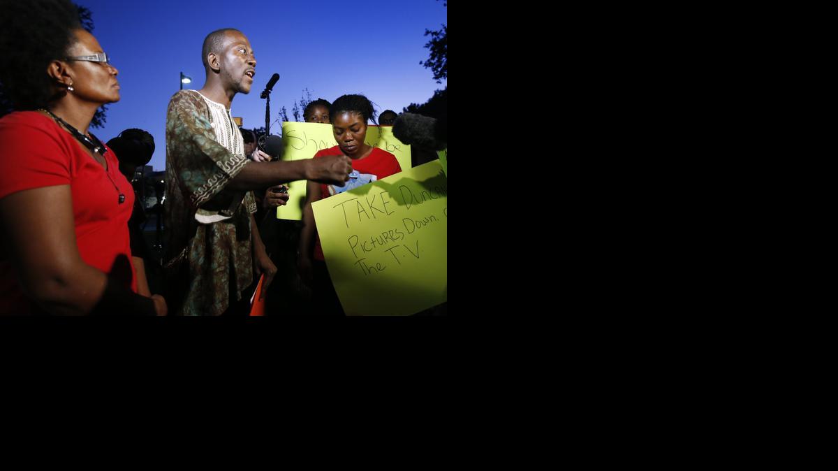 
Aaron Yah, center, makes comments to reporters as he stands with Saymandy Lloyd, left, and Youngor Jallah during a protest outside of Texas Health Presbyterian Hospital Dallas, Thursday.

