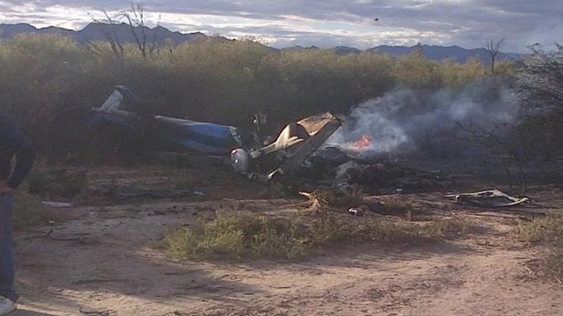 
A man stands near one of two helicopters that crashed near Villa Castelli in the La Rioja province of Argentina, Monday
