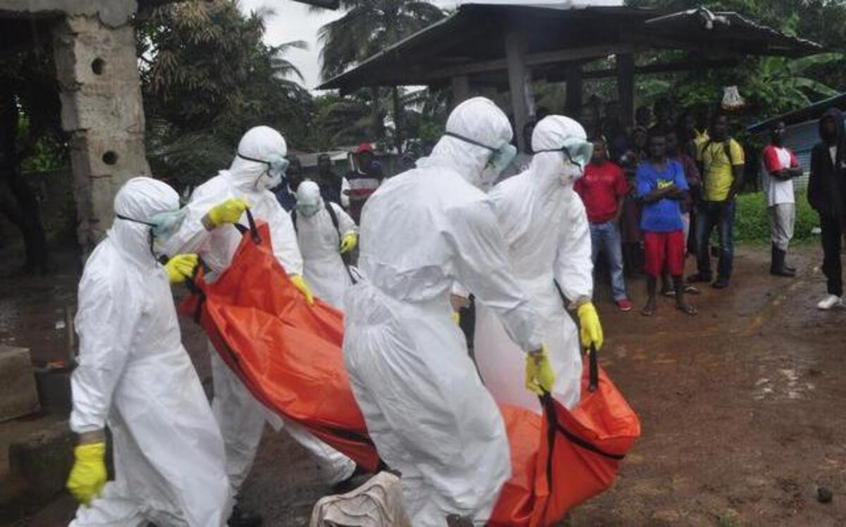 
Health workers carried the body of a man suspected to have died of the Ebola virus Tuesday on the outskirts of Monrovia, Liberia.
