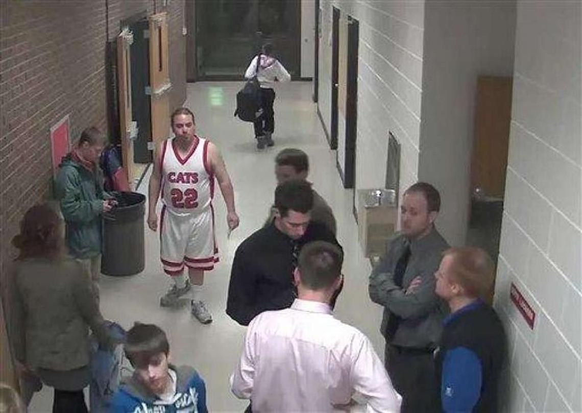 Security camera footage provided by Bismarck Schools shows Sherwin Shayegan of Bothell, Wash., dressed in a basketball uniform in a hallway at Century High School in Bismarck, N.D., in 2012. Dubbed the “Piggyback Bandit,” Shayegan crashed school sporting events in at least five states from Washington to Minnesota, in some cases coaxing players to give him a piggyback ride.