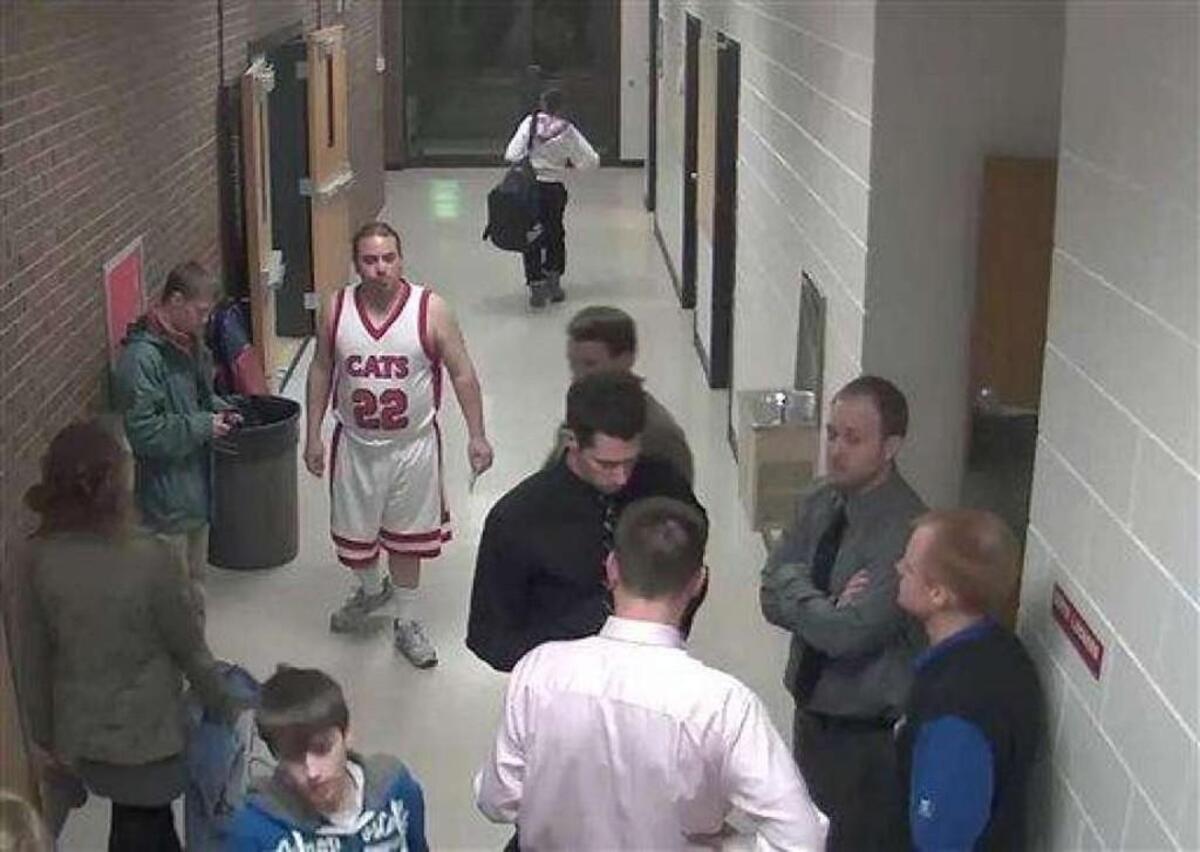 Security camera footage provided by Bismarck Schools shows Sherwin Shayegan of Bothell, Wash., dressed in a basketball uniform in a hallway at Century High School in Bismarck, N.D., in 2012. Dubbed the “Piggyback Bandit,” Shayegan crashed school sporting events in at least five states from Washington to Minnesota, in some cases coaxing players to give him a piggyback ride.