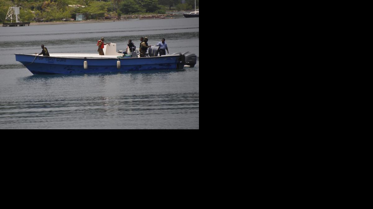 
Jamaican Defence Force members return to Port Antonio Marina in Portland, Jamaica, Saturday, Sept. 6, 2014, after a fruitless search for a plane that crashed into the ocean a day earlier. 
