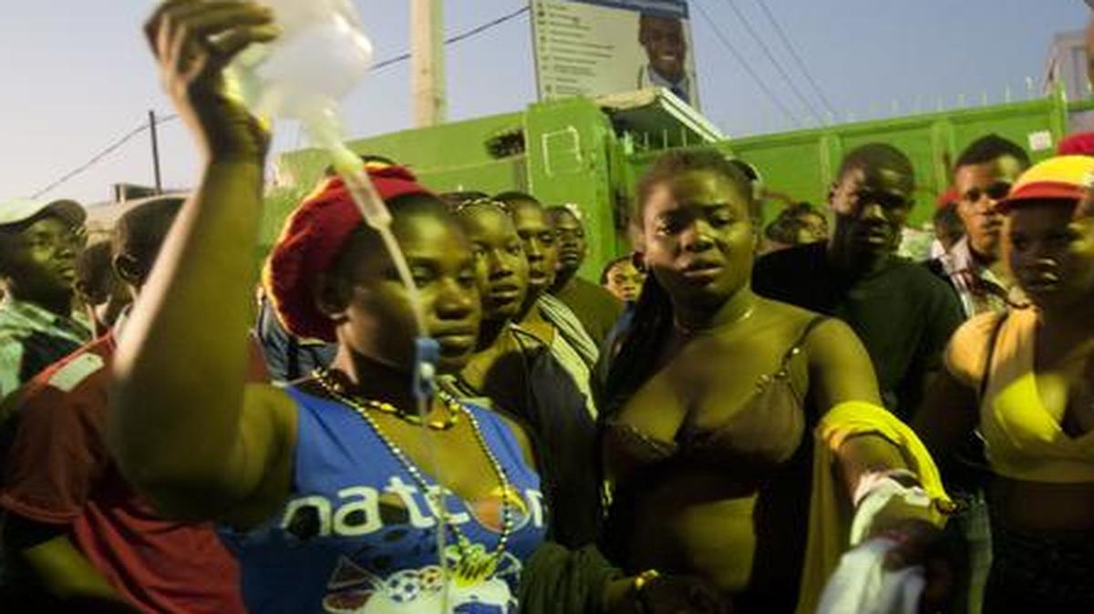 
Injured revelers wait outside the General Hospital in Port-au-Prince, Haiti, early Tuesday
