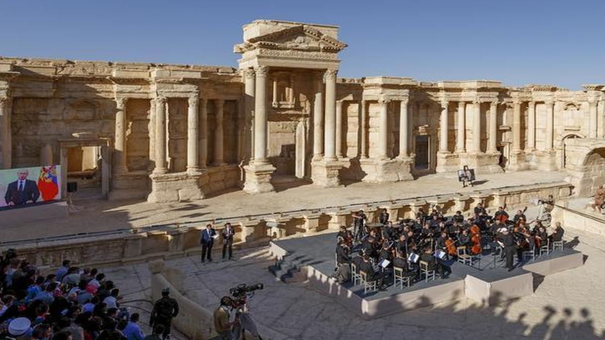 On Thursday, Russia deployed a symphony orchestra to play a concert in the Syrian city of Palmyra, recently reclaimed from Islamic State occupation. Russia flew reporters from Moscow to Syria and then bused them to Palmyra to see the performance. The concert, staged in an ancient amphitheater, was broadcast to TV audiences back in Russia.