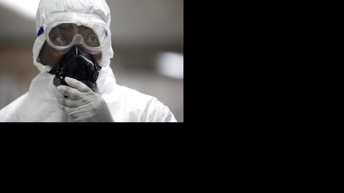 
A Nigerian health official waits to screen passengers for the Ebola virus at the arrivals hall of Murtala Muhammed International Airport in Lagos, Nigeria.
