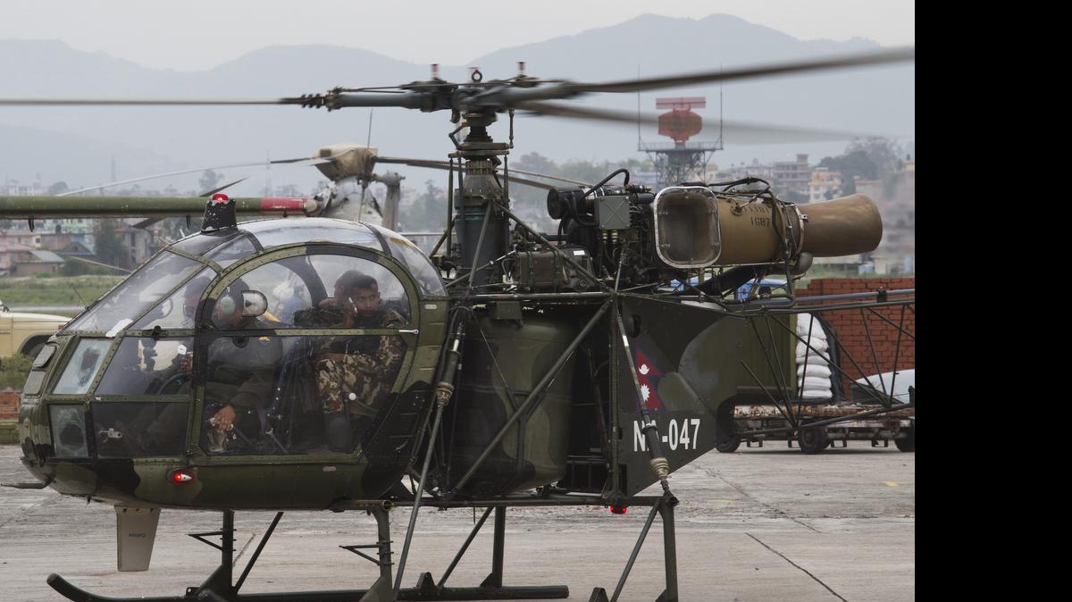 
The Nepalese army chopper that spotted the suspected wreckage of a U.S. Marine helicopter lands at the airport in Kathmandu, Nepal
