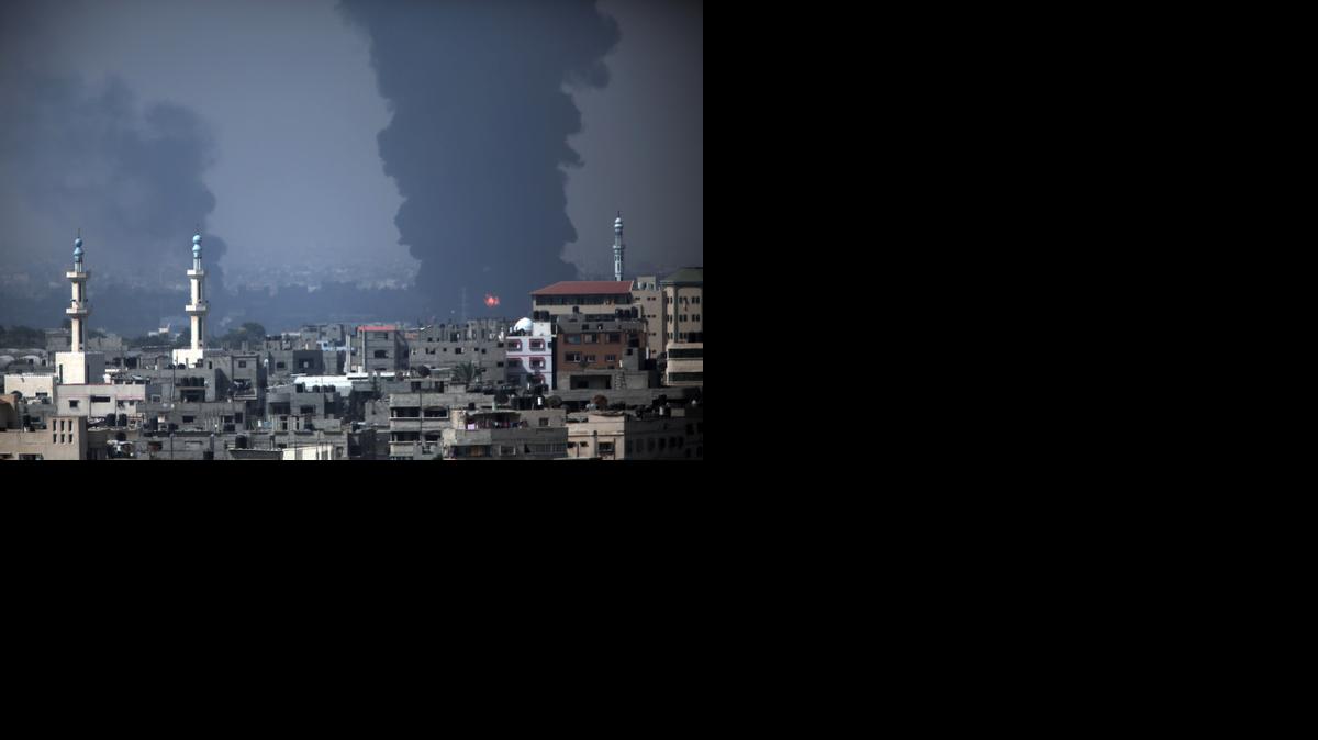
Smoke rises from Gaza's electricity distribution company after it was hit by Israeli strikes in the Nusayrat refugee camp, central Gaza Strip, Tuesday, July 29, 2014. 
