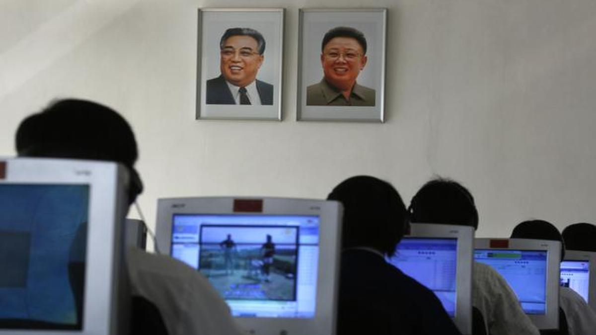 
North Korean students use computers in a classroom with portraits of the country's later leaders Kim Il Sung, left, and his son Kim Jong Il hanging on the wall 
