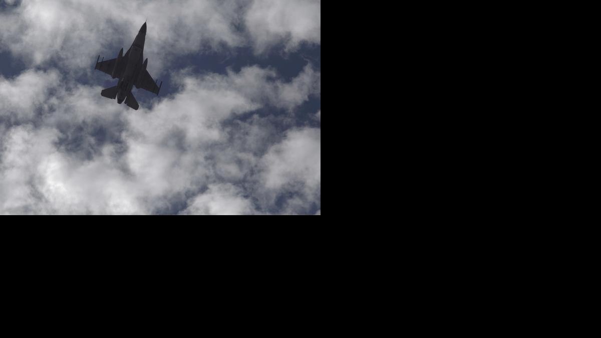 
A Jordanian Air Force fighter jet flies over the village of Ai as Jordanian King Abdullah II visits to offer his condolences to the tribe of the slain Jordanian pilot, Lt. Muath al-Kaseasbeh 
